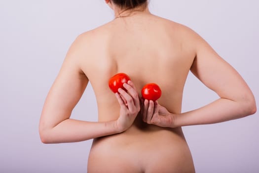 Female with tomatoes on chest and back, concept of healthy food and female health