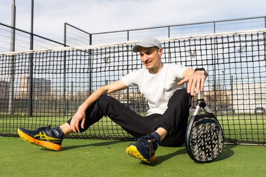 Ukraine Kyiv, March 31 2024. Guy playing padel and hitting and having fun. High quality photo