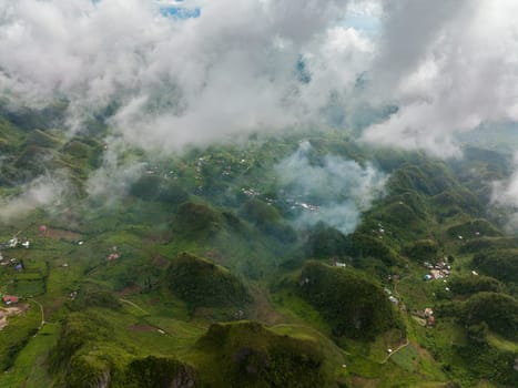 Aerial drone of mountain peaks and hills covered with green vegetation and mist. Osmena Peak. Mountain landscape. Cebu Philippines.