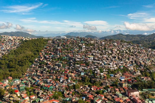Aerial drone of Baguio City with colorful houses in a mountainous province. Philippines, Luzon.