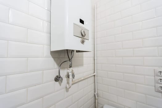 Broken Modern Water Gas Heater Next to Shower Cabin Inside Elegant Clean Bathroom Interior. High quality photo