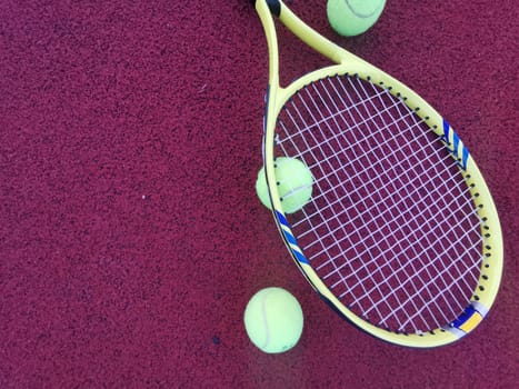 yellow tennis balls and two racquet on hard tennis court surface, top view tennis scene. High quality photo