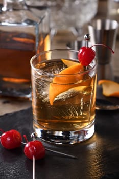 Cocktail Old Fashioned is an old-fashioned sophistication of whiskey and sweet syrup. Served with ice, orange zest and Maraschino cherry. 