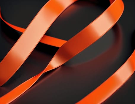 The image is a photograph of a long, orange ribbon with a smooth, curved surface.