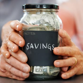 Married hands, money and mason jar for insurance, retirement or savings plan. Senior couple, cash or bills for pension, banking or investing together and generational wealth opportunity for family.