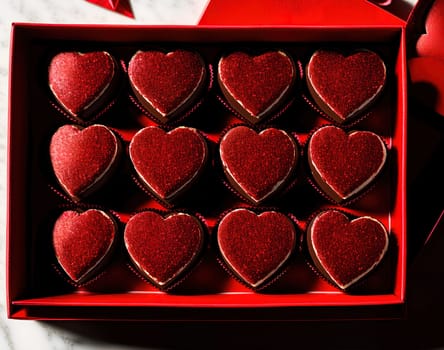 The image shows a red heart-shaped box filled with chocolate hearts.