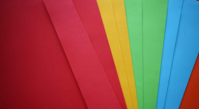 Set of colourful envelopes lying in fantail shape closeup