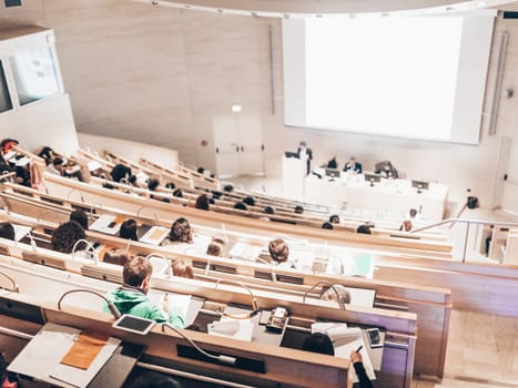 Conference and Presentation. Audience at the conference hall. Business and Entrepreneurship. Faculty lecture and workshop. Audience in the lecture hall. Academic education. Student making notes.