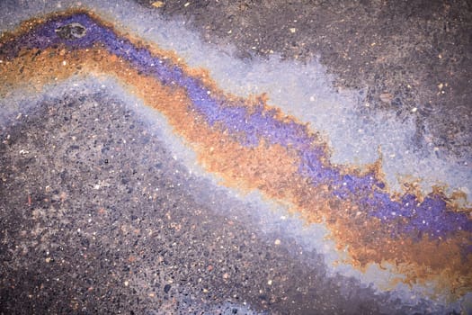 Puddle gasoline background, wet oil multicolored rainbow pollution spill