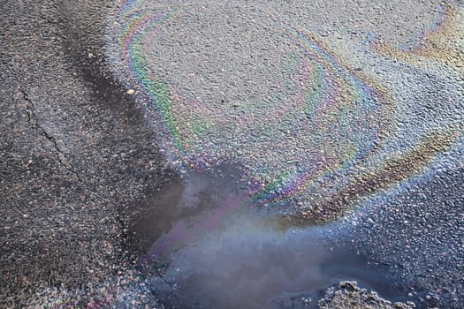 Oil stain on Asphalt, color Gasoline fuel spots on Asphalt Road as Texture or Background