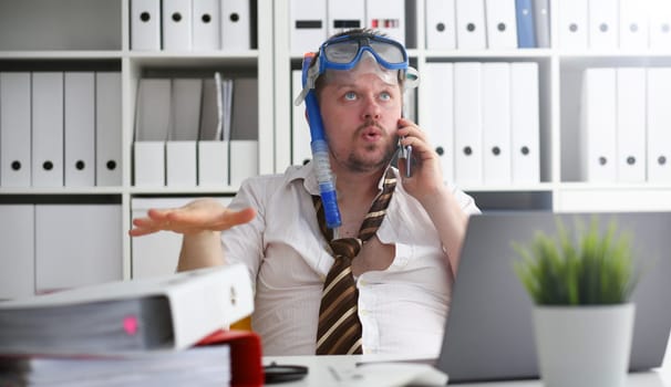 Man wearing suit and tie in goggles and snorkel talk cellphone at office workplace ready to take off portrait. Count days to leave annual day off workaholic freedom fun tourism resort idea concept