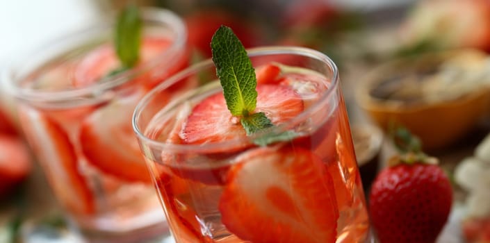 Strawberry punch home made cocktail closeup on wood background