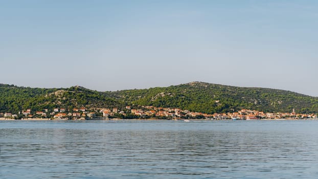 Village houses with red roofs on seashore of Adriatic Sea, Dugi Otok island, Croatia