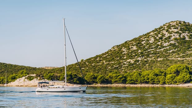 Modern yacht with tourists sailing off coast of Dugi Otok island in Adriatic Sea, Croatia