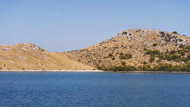 Scenic landscape with rocks, pines and hills on seashore, Dugi Otok island in Adriatic Sea, Croatia