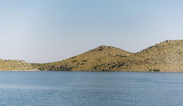 Panoramic landscape, idyllic beach with dry hills of Dugi Otok island in Adriatic Sea, Croatia