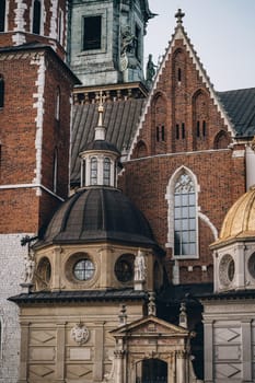 King statue, mosaic lancet and round windows and decorative columns on walls of Wawel Royal Castle, Krakow, Poland