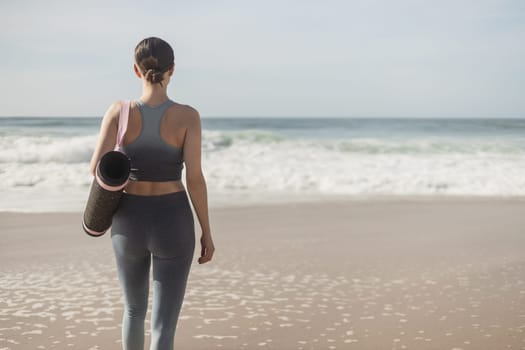 Woman practicing yoga outdoor. Beautiful girl practice asana in online class. Calmness and relax. Background with sunrise