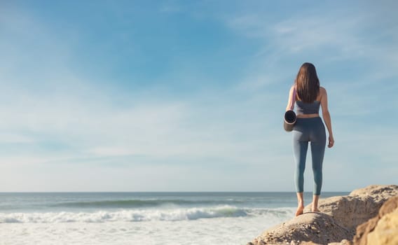 Woman practicing yoga outdoor. Beautiful girl practice asana in online class. Calmness and relax. Background with sunrise