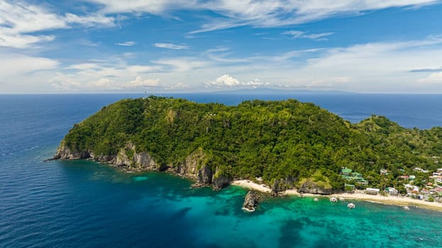 Top view of Apo Island with a beautiful beach and marine reserve. Popular dive site and snorkeling destination with tourists. Negros, Philippines.