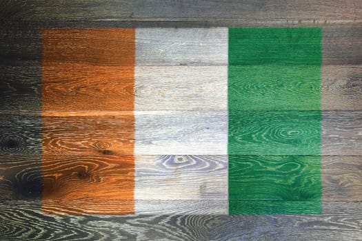 Ivory Coast Cote divoire flag on rustic old wood surface background