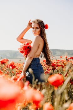 Woman poppies field. portrait of a happy woman with long hair in a poppy field and enjoying the beauty of nature in a warm summer day