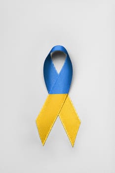 ukraine blue yellow ribbon in the middle on white background. concept needs help and support, truth will win