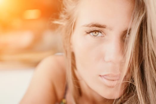 Happy woman portrait in cafe. Boho chic fashion style. Outdoor photo of young happy woman with long hair, sunny weather outdoors sitting in modern cafe