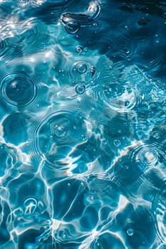 A close up of a liquid pool of azure water with bubbles creating a mesmerizing pattern. The fluid aqua reflects the electric blue sky above, making a beautiful water resource