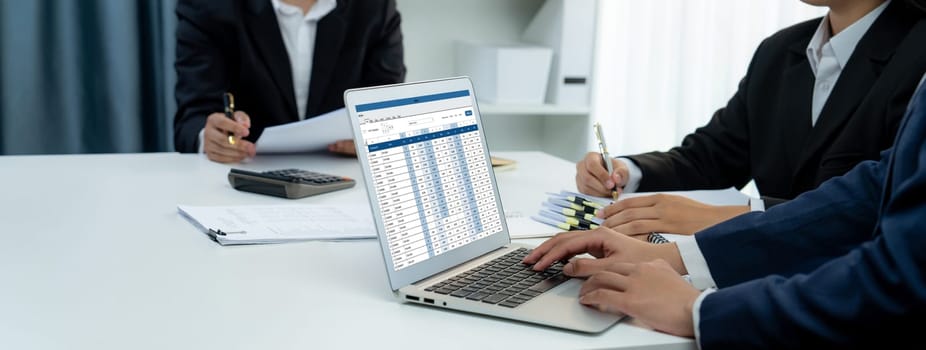 Corporate accountant team use accounting software on laptop to calculate and maximize tax refund and improve financial performance base on financial data. Modern business accounting . Shrewd