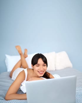 Woman, home and happy with laptop in bed for streaming movies and series on website. Female person, smile and online with technology for internet, communication and entertainment in bedroom