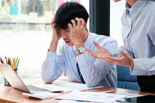 One colleague appears stressed and overwhelmed while another offers explanations or solutions amidst a business discussion.