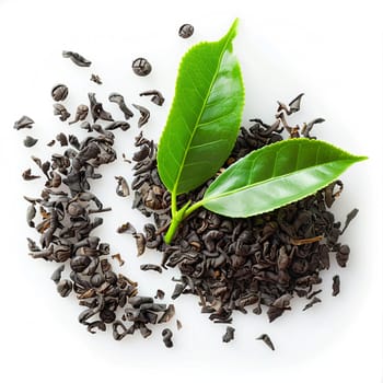 Top view of black tea leaves and vibrant green leaf isolated on white background, concept of natural beverages