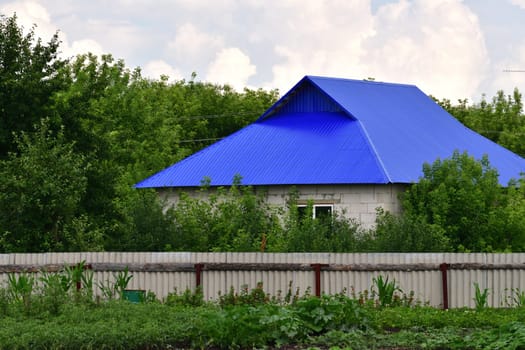 Rural house made of silicate brick with a metal roof, Russia