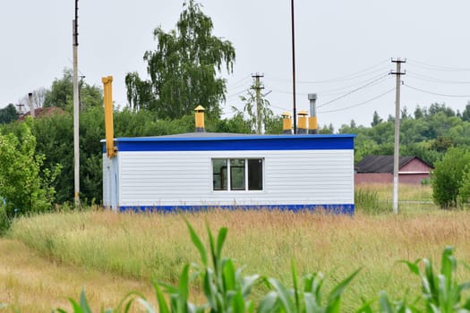 Gas pipeline and the gas distribution station in village. Russia