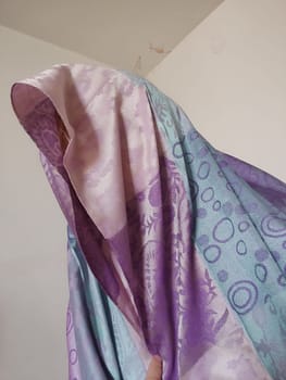 pink blue purple silk scarf on head, clothing fabric. High quality photo