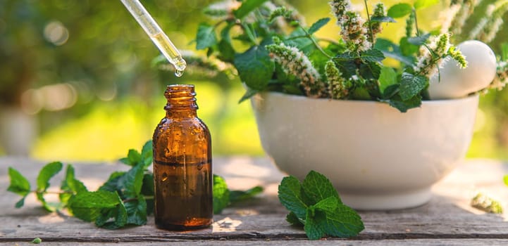 Peppermint essential oil in a bottle. selective focus. nature.