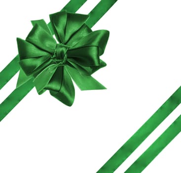 Tied bow made of green silk ribbon on an isolated background, decor for a gift. Top view