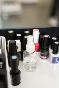 Nail and cuticle care products. Cosmetic oil for softening cuticles. Nails polish on background.