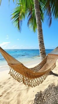 Hammock on beach under palm tree with blue sky and ocean
