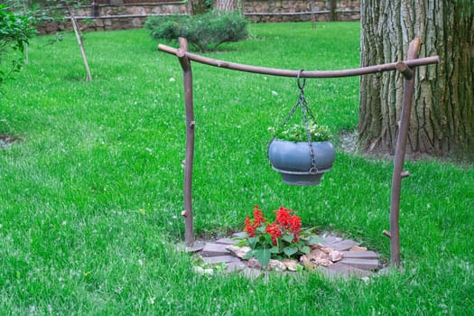 a cauldron for cooking on a decorative fire. photo