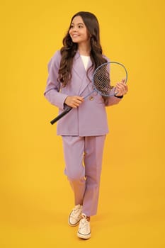 Teen girl badminton player in suit with badminton racket isolated on yellow background