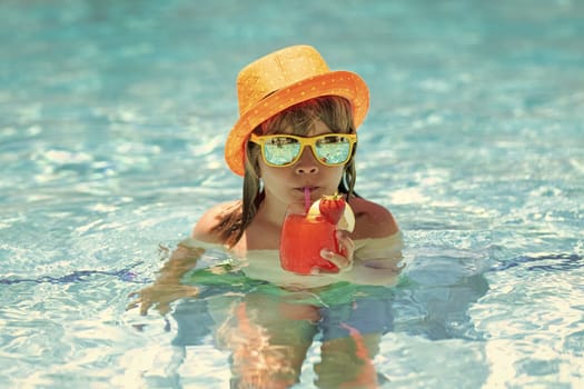 Summer kids cocktail. Happy little boy in swimming pool. Children summer vacation