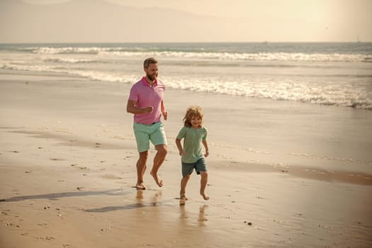 father and son running on summer beach together, togetherness.