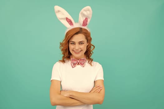 glad easter woman in bunny ears and bow tie on blue background.