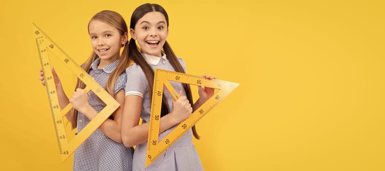 School girls friends. Happy teen girls hold triangular rulers. School education. Geometry lesson. Banner of school girl student. Schoolgirl pupil portrait with copy space