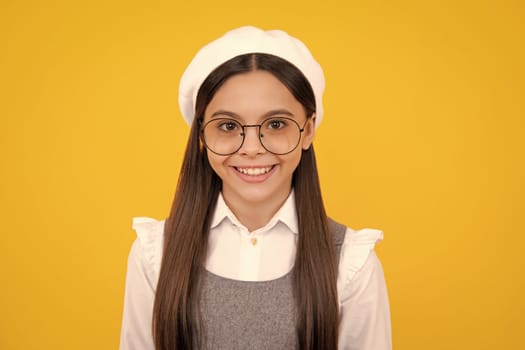 Portrait of pretty teen girl. Latin or hispanic teenager child isolated on yellow background. Happy face, positive and smiling emotions of teenager girl
