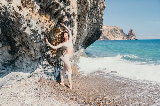 Happy young attractive brunette woman in red swimsuit, on the beach and sea background. Holiday vacation and travel concept.