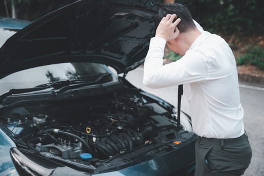 Asian businessman car broken breakdown, young stressed man having trouble car failure problem looking in frustration at failed engine in the morning, accident on road outdoor, late for work