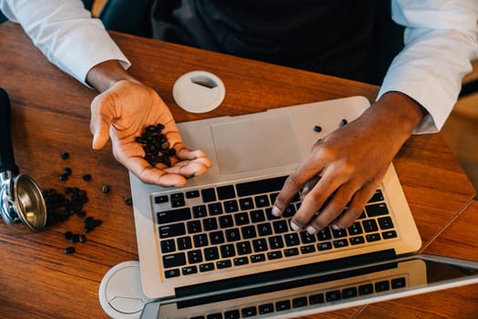 At coffee roastery the business owner and barista utilizes laptop to verify bean quality. With meticulous checks and technology ensuring premium beans is key. Business owner verification is evident.